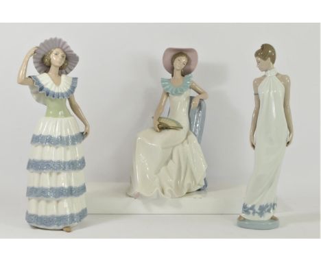 Three Nao by Lladro figurines of ladies to include, Lady with Fan 1250 32cm, Lady with blue and white dress 32cm, and Eleganc