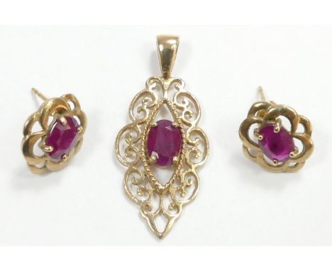 A 9ct gold openwork ruby pendant, 29mm and a matching pair of ear rings, 2.9gm 