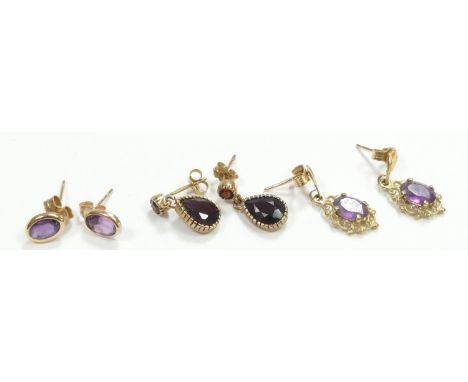 A 9ct gold pair of rear shape garnet ear rings and two pairs of amethyst ear rings, 3.6gm 