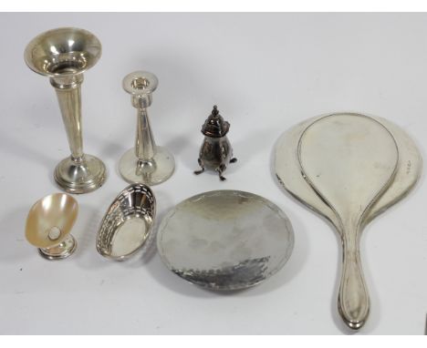 A silver hand mirror, Birmingham 1915, a silver vase, Birmingham 1974, a small candlestick, Birmingham 1919, a pepper pot, Bi