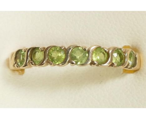 A 9ct gold and peridot seven stone ring, R 1/2, 1.8gm 
