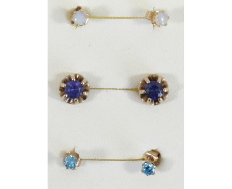 A 9ct gold opal set pair of ear studs, a synthetic sapphire pair and a CZ pair, 2.1gm 