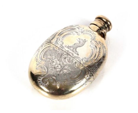 A Victorian silver hip flask, with rich foliate engraved decoration monogram and family crest, detachable cup and screw actio