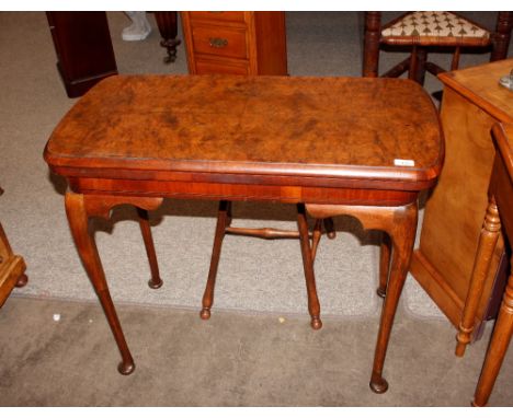 A burr walnut card table, having fold over swivel top raised on cabriole supports and pad feet, 88cm wide&nbsp;