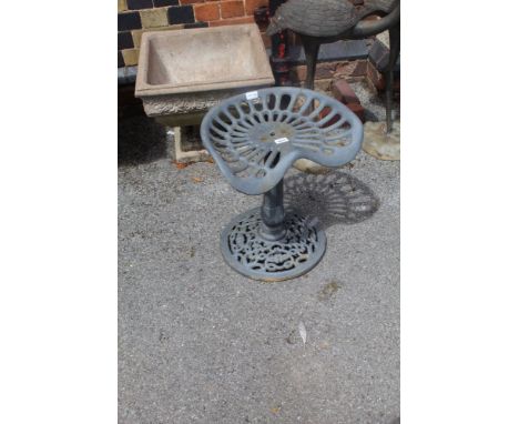 A PAINTED METAL GARDEN SEAT, the top in the design of a vintage tractor 