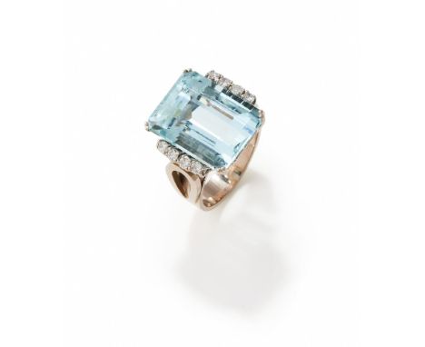 AN AQUAMARINE DRESS RING  The step cut aquamarine with canted corners flanked by rows of brilliant cut diamonds, to shaped ho