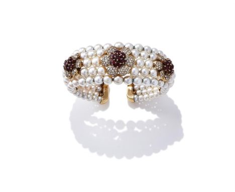 A CULTURED PEARL, RUBY AND DIAMOND BANGLE Composed of five graduated rows of cultured pearls, set with three flowerheads with