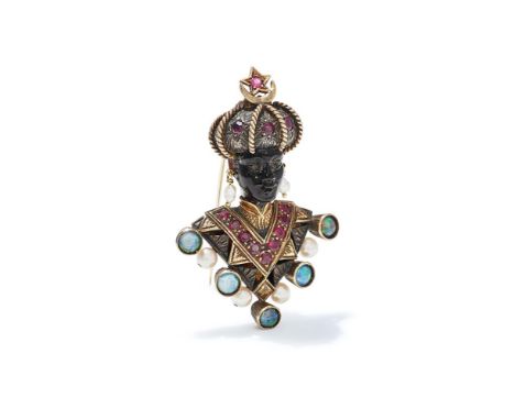Y NARDI, A GEM AND TORTOISESHELL 'MORETTO' BROOCH The carved tortoiseshell face with a circular cut ruby and rose cut garnet 