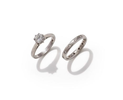 A DIAMOND SINGLE STONE RING AND DIAMOND SET BAND The brilliant cut diamond, weighing 1.01 carats, in a platinum eight claw mo