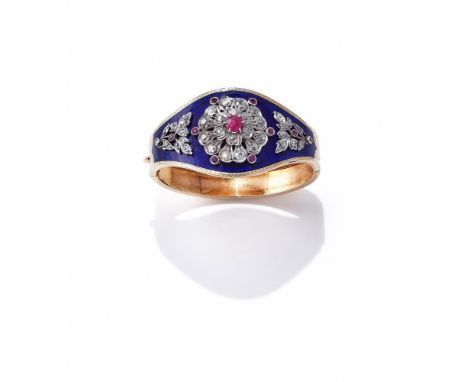 A RUBY, DIAMOND AND ENAMEL BANGLE The hinged tapered bangle with blue enamel front, set with a cushion shaped and circular cu