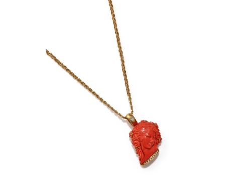 Y A CORAL AND DIAMOND PENDANT NECKLACE The coral carved with a female bust with flowers in her hair, to a diamond set base an