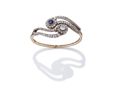 AN EARLY 20TH CENTURY SAPPHIRE AND DIAMOND BANGLE Of hinged crossover design, composed of a circular cut sapphire and old cut