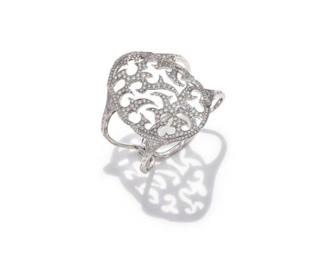 STEPHEN WEBSTER, A DIAMOND BANGLE The oval openwork front of abstract openwork design, set throughout with brilliant cut diam