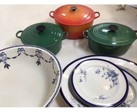 Le Creuset casserole dishes orange and green, Worcester blue and white plates also with a blue and white bowl. 