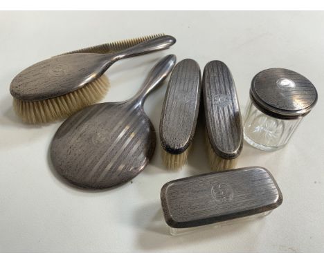 A silver dressing table set.