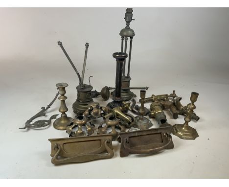 A large quantity of brass and copper items including taps, door knockers, lamps and candle sticks