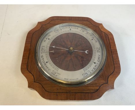 A wooden wall barometer with presentation plaque on reverse dated 1933W:30cm x D:4.5cm x H:30cm