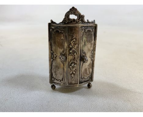 A Silver miniature armoire, stamping 925 with makers mark MF. Weight approx 36gm W:4cm x H:7cm