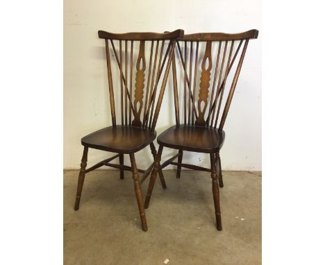 A pair of Ercol style stick back chairs. W:36cm x D:44cm x H:101cm