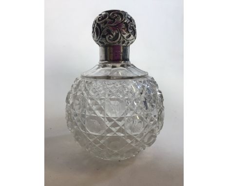 A silver topped scent bottle cobbled glass. Birmingham 1912.H:13cm