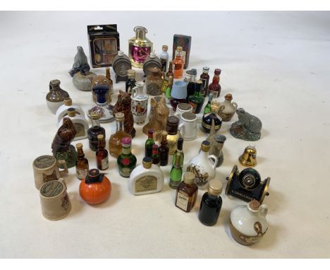 A large collection of miniatures including whisky, brandy, and ceramic miniatures. A few empties for display only 