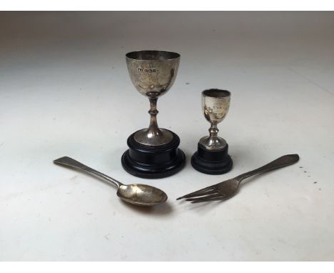Sterling silver items to include two small trophies on turned wooden plinths. 3.1oz. 