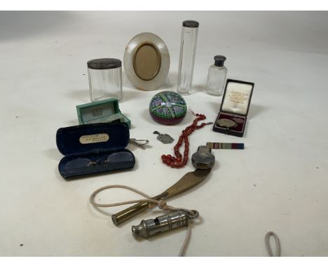 A collection of vintage items including silver topped dressing tables jars, a paper weight, an Acme whistle, a lighter and a 