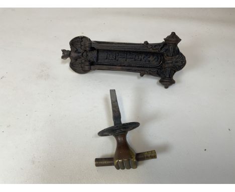 A cast iron Kendrick and sons door knocker with bat detail together with a brass safe handle