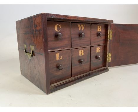 A mahogany chest with six lettered drawers, brass campaign handles to the side. With large lockable door with key. W:46cm x D