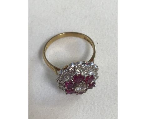 A London hall marked 750, 18ct Diamond and ruby cluster ring. 