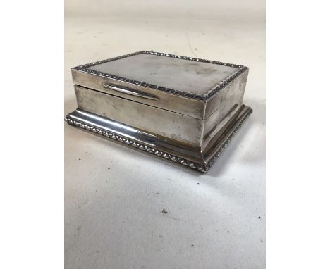 A sterling silver cedar lined cigarette box . by Stuart Dawson & Co London 1913. Gross. 13.8oz. W:13cm x D:11cm x H:6cm