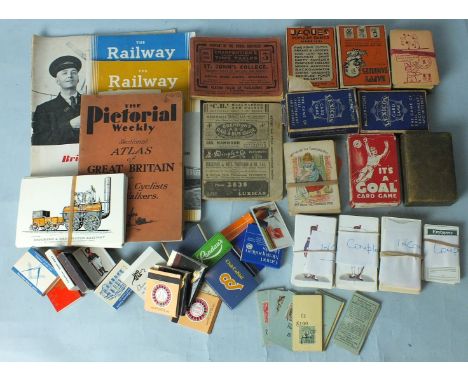 A small quantity of railway and bus timetables, c1940, Railway magazines, etc, seven packs of playing cards, a small quantity