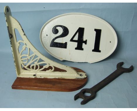 A GWR cast iron wall bracket, a cast iron wagon plate "241", (af), and a GWR water gauge spanner, (3)