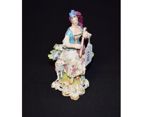 A Derby Patch Mark figure, of a Musician, seated playing a mandolin, wearing a blue corsetted and floral dress, a lamb at her