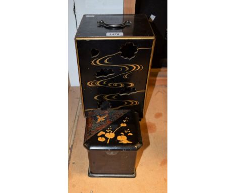 A Japanese black lacquer pillar table cabinet, slightly oversailing top above sliding covers recto and verso, blind sides, de