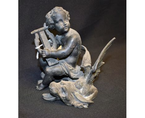 A cast spelter figure of a cherub playing a lyre