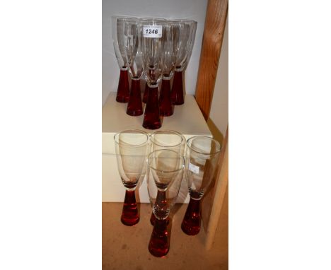 A set of ten clear and ruby red glass champagne flutes, clear bowls, red stems (10)