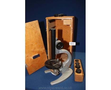 A boxed Microscope with lens.