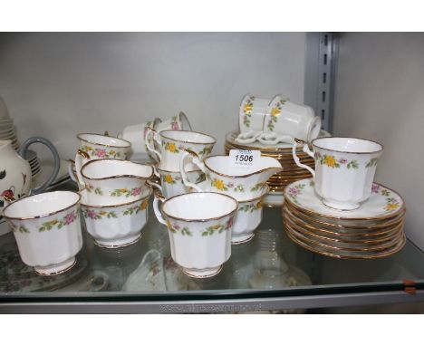 A quantity of Elizabethan bone china in yellow and pink rose pattern including cups, saucers, tea plates, sugar bowls, cream 