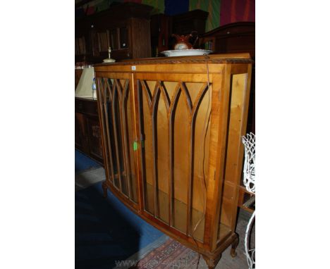 A good 1920's Walnut china Display Cabinet having bow front with rope twist moulded edge top, pair of opposing seven pane gla