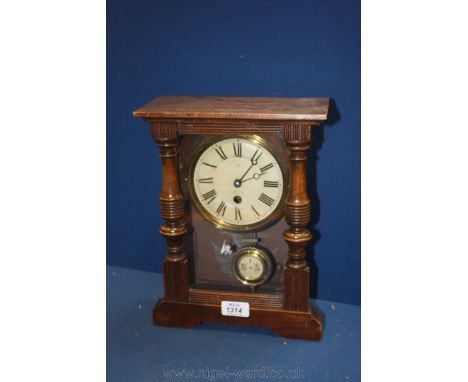 A mixed woods Mantel Clock of angular form with turned half-round pillars to either side and having spring driven movement, t