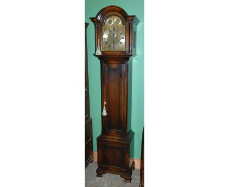 A 20th c. Oak Grandfather Clock by "S. Smith & Sons Ltd., Trafalgar Square, London", having dome topped hood with fluted colu