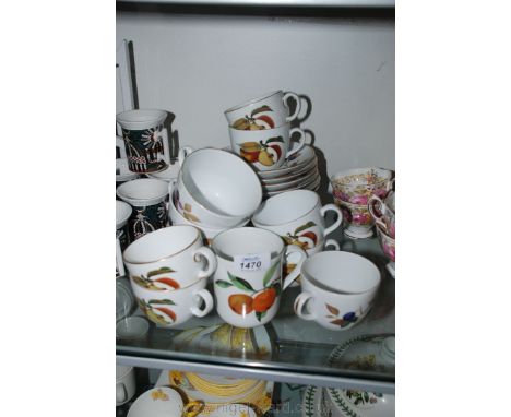 A Royal Worcester Evesham part Teaset comprising seven Tea Cups, seven saucers, three Breakfast Cups, one Mug, five Tea Plate