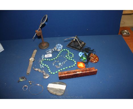 A box of miscellanea including old eye glass on stand, small sculpture, enamel necklaces, etc.