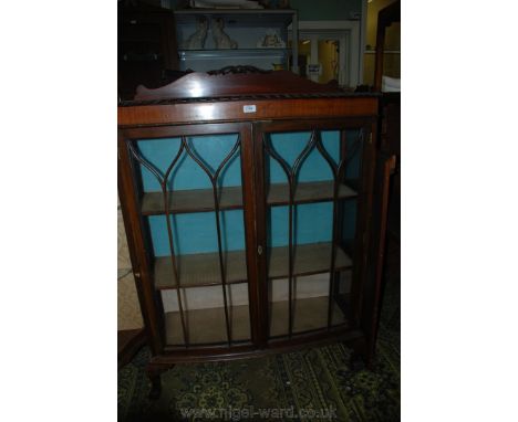 A 1930's Mahogany bow fronted china Display Cabinet with gallery back and rope twist carved edge top over a pair of opposing 