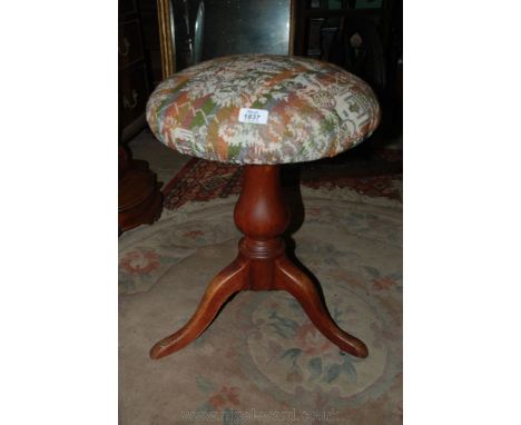 An adjustable Piano Stool with tripod legs and circular tapestry seat