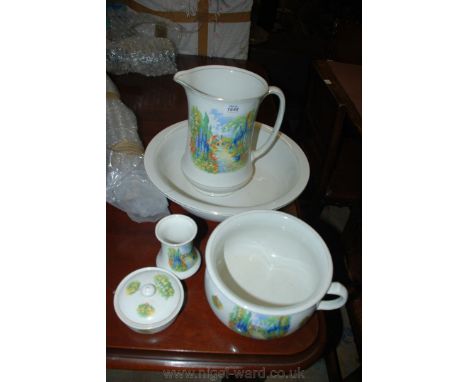 A Bedroomware Jug and Basin, soap dish, chamber pot, etc. in a cottage garden design.