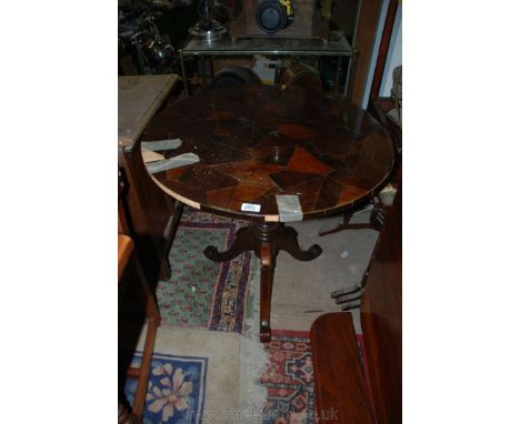 A modern tripod Table, Georgian in style with multi-wood erratic pattern veneered top, standing on turned pedestal base and t