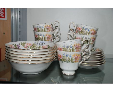 A Paragon Tea Set in 'Country Lane' design, comprising six Cups, seven saucers, seven Tea Plates, Bread and Butter Plate and 