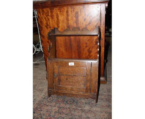 A hanging shelf with cupboard